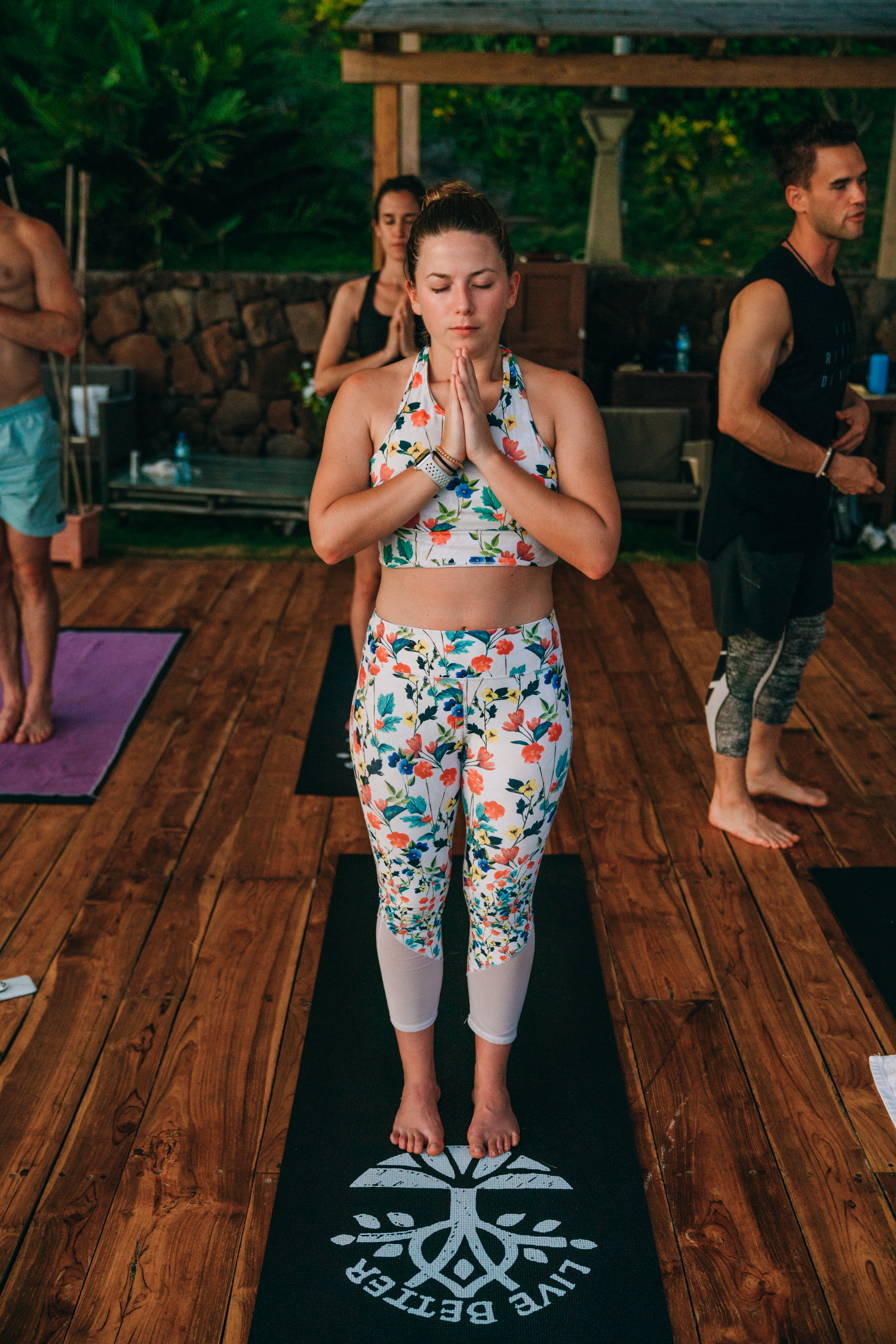 girl meditating on yoga deck