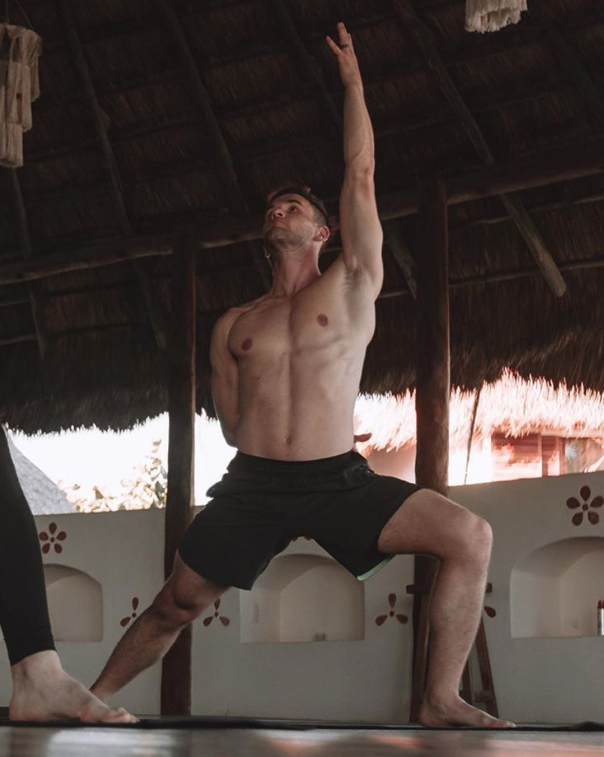 guy doing yoga in Mexico on a yoga deck